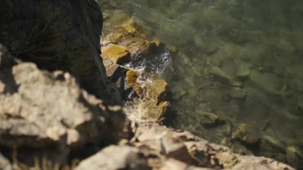 Uçurumun kenarından aşağıdaki suya bak, su kayalara çarpıyor. — Stok video
