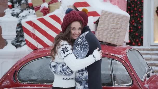 Guy hugs and kisses girl,concept of Christmas,new year.next to boxes with gifts — Stock Video