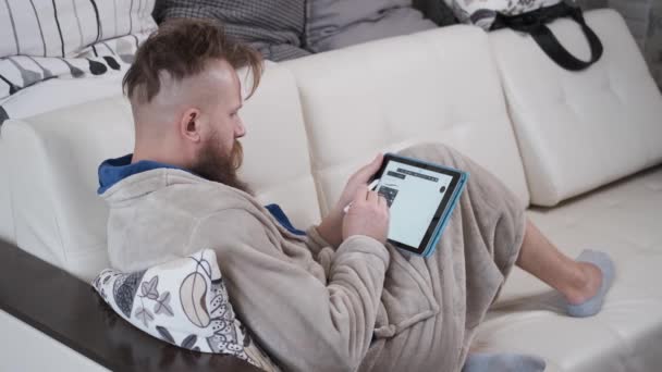 Man in housecoat drawing on tablet,working at home,designer in quarantine — Stock Video