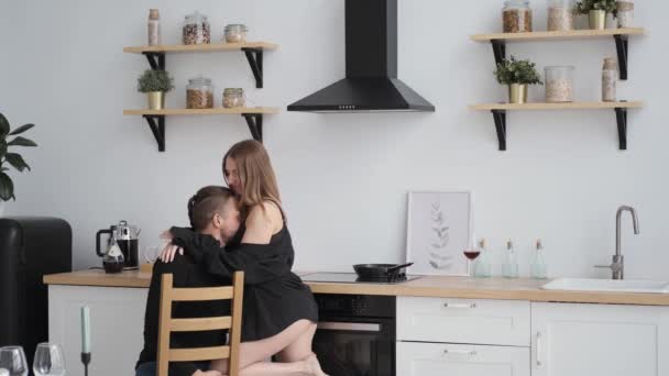 Casal erótico flerta em casa kitchen.on mesa vinho tinto caucasiano — Vídeo de Stock