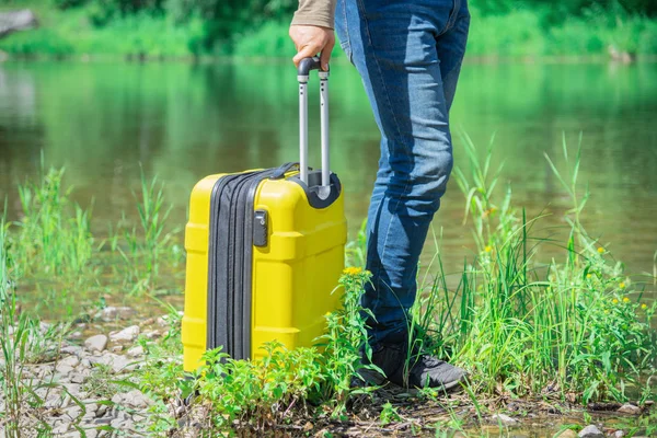 Man Jeans Riverbank Grass Yellow Suitcase Travel Tourism Concept — Stock Photo, Image