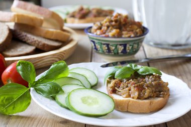 Traditional Russian summer appetizer - eggplant spread with vegetables clipart