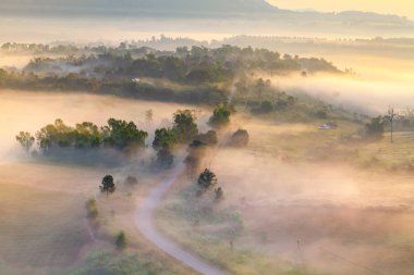 Misty morning sunrise in Khao Takhian Ngo View Point at Khao-kho clipart