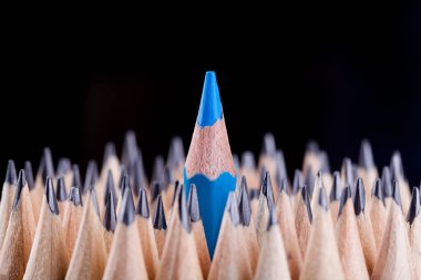 One sharpened blue pencil among many one clipart