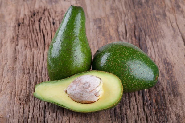 Avocado on a wooden background — Stock Photo, Image