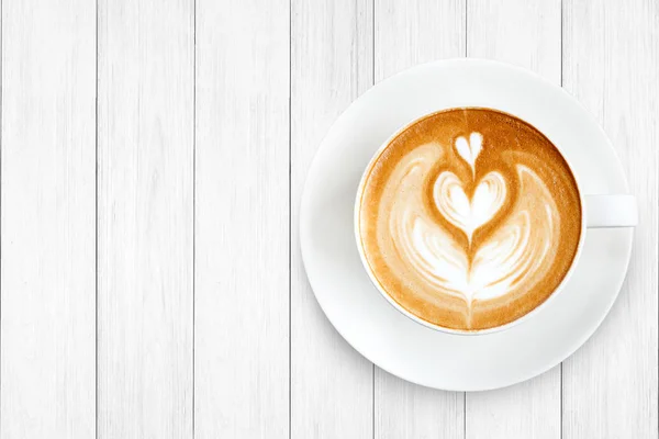 Ovanifrån latte art kaffe på trä bakgrund — Stockfoto