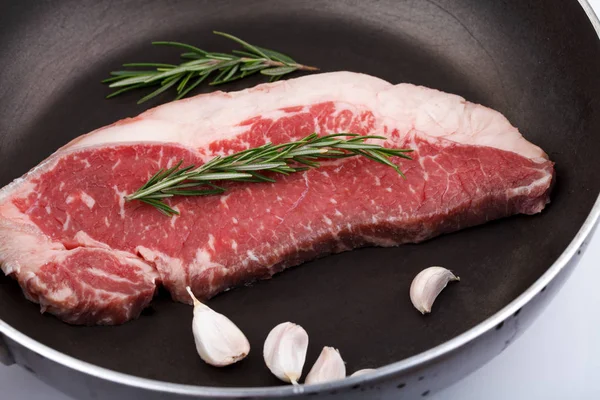 Raw red sirloin steak with rosemary