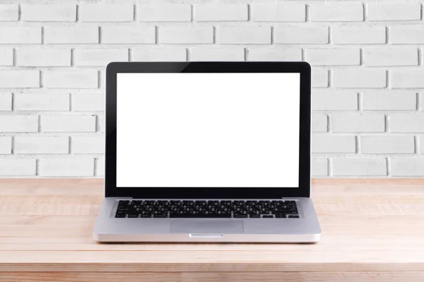 Front view of the laptop is on the work table brick background — Stock Photo, Image