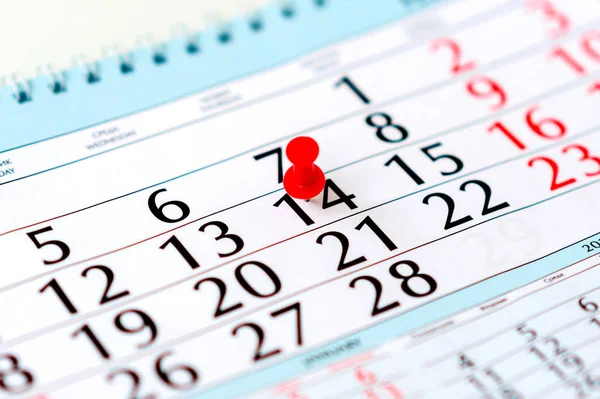 Red pin on calendar with marked date of Valentines Day