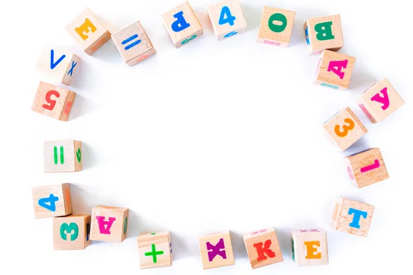 Kids toys wooden cubs with letters and numbers on white background. — Stock Photo, Image