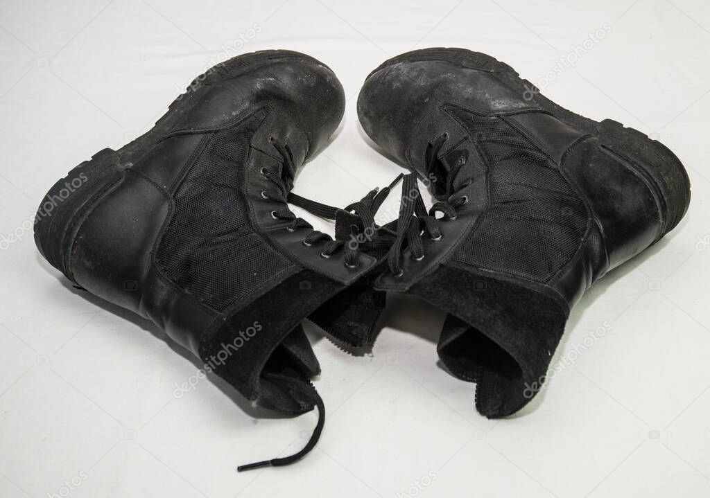 Old, used military boots, black, isolated