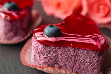 Heart shaped dessert with blueberry and glazing for romantic evening