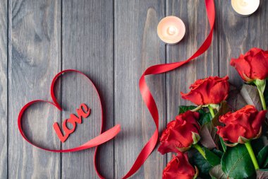 Romantic Saint Valentine wooden background card with bouquet of beatiful red roses and Love lettering