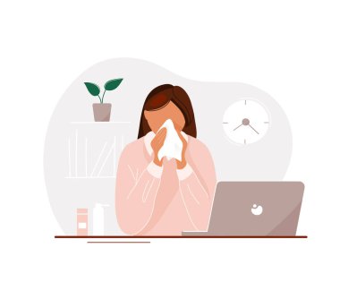 Young woman with flu in office blowing her nose