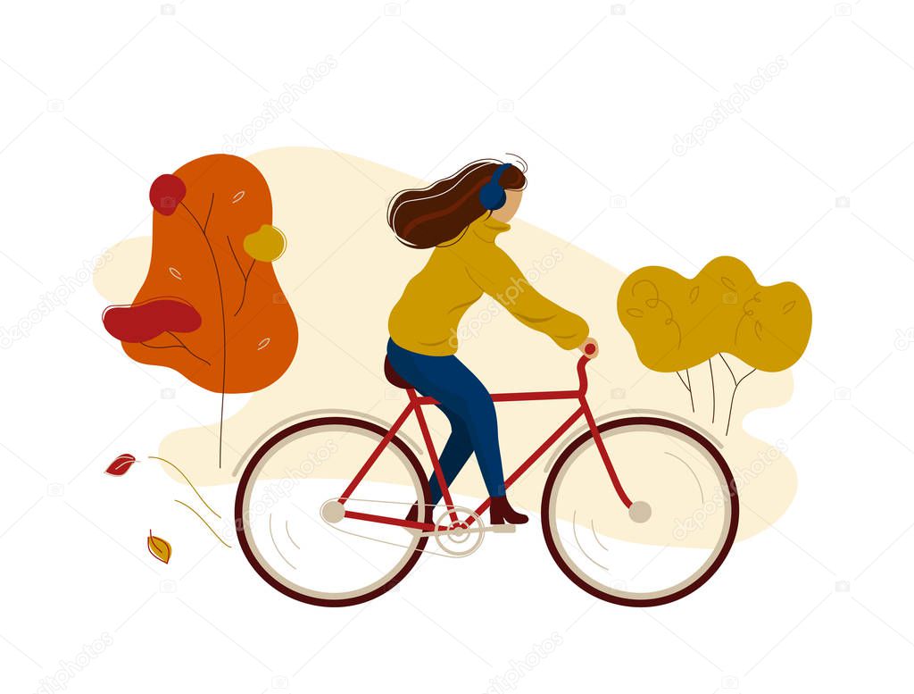Young woman riding bicycle in autumn park