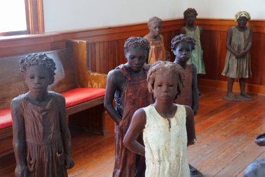Edgard, Louisiana, U.S.A - February 2, 2020 - The statues of the African American kids inside the church near Whitney Plantation clipart