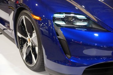 Philadelphia, Pennsylvania, U.S.A - February 9, 2020 - The headlights of the blue metallic 2020 Porsche Taycan 4S all electric sports sedan
