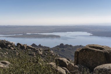 Panoramic view of Santillana reservoir, since La Pedriza, National Park of mountain range of Guadarrama in Manzanares El Real, Madrid, Spain. clipart