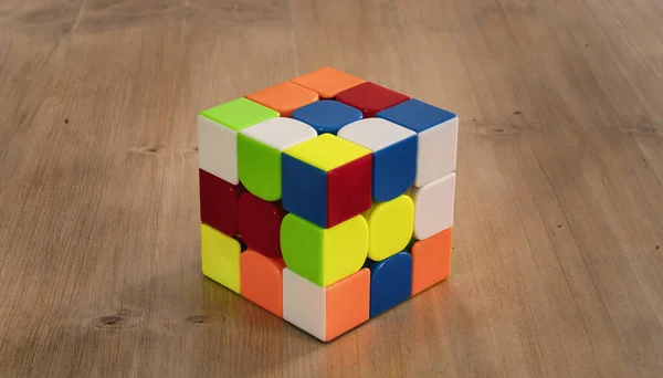 Several Rubik cubes intelligence toys unsolved, in a wood table