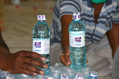 Burdwan, Purba Bardhaman Bölgesi, Batı Bengal / Hindistan - 19.04.2020: Burdwan merkezli kuruluş 'Palla Yolu Pallimongal Samity' Kamu Özel Ortaklığı projesinde alkol bazlı el dezenfektanları üretiyor.