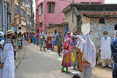 Burdwan Town, Batı Bengal / Hindistan - 26.04.2020: 'Ma-Mati-Manush Seba Pratisthan' organizasyonu, Ramazan ayı boyunca, Roman Coronavirus 'un ortaya çıkışı nedeniyle para kazanamayan kişilere yiyecek dağıtıyor.