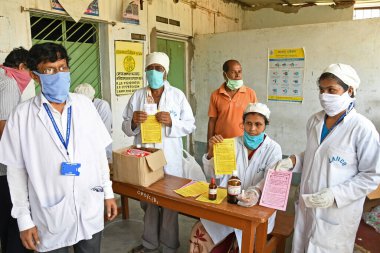Burdwan, West Bengal / India - 14.05.2020: Homeopathic medicine 'Arsenicum Album 30' is being distributed free of cost to increase immunity against Novel Coronavirus (COVID-19) under the direction of the Ministry of AYUSH, Government of India. clipart