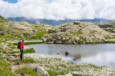 Kadın trekker dağ gölü yürüyüş.