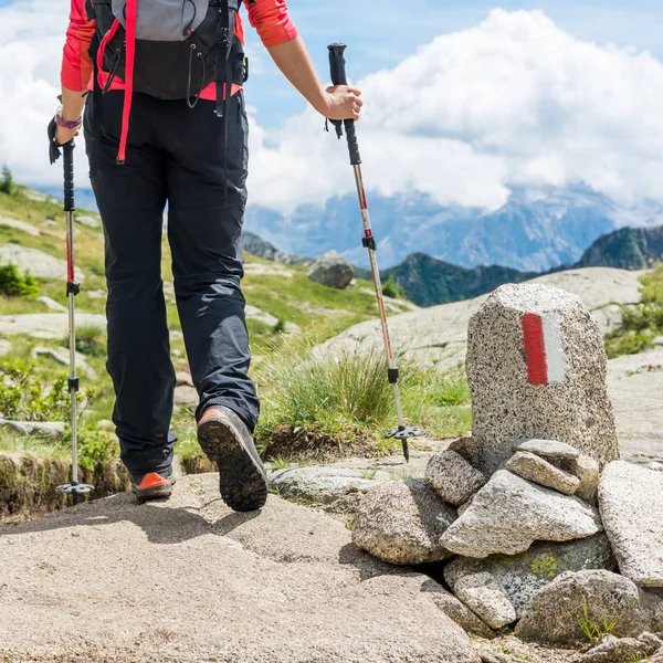 Hiker passing white and red trail sign. — Stock Photo, Image