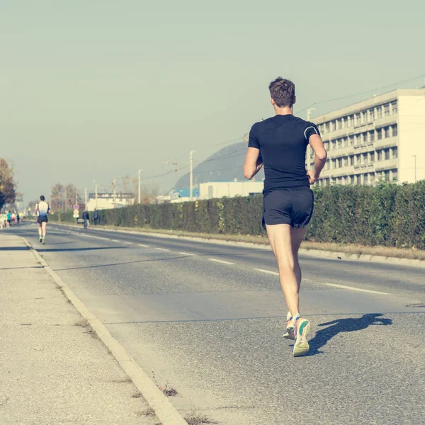 Lonely marahon runner catching up. — Stock Photo, Image