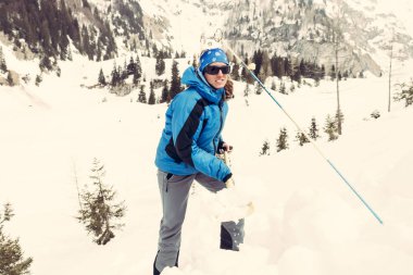 Female rescuer searching for avalanche victim. clipart
