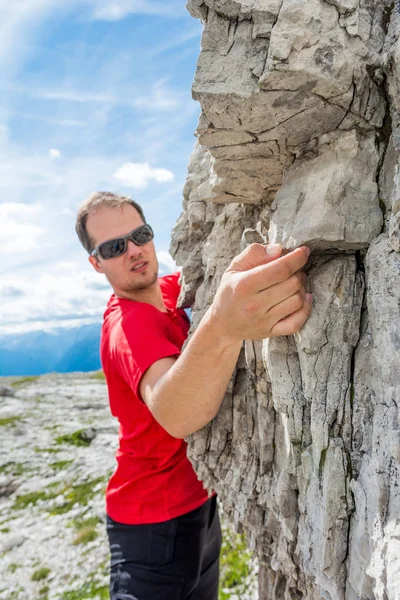 Active male free climbing outdoor.