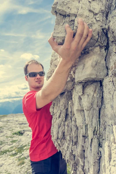 Active male free climbing outdoor.