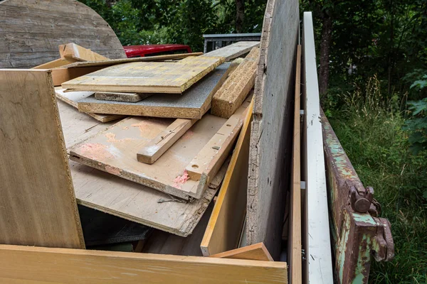 Broken furniture broken planks stacked and ready for transportation.