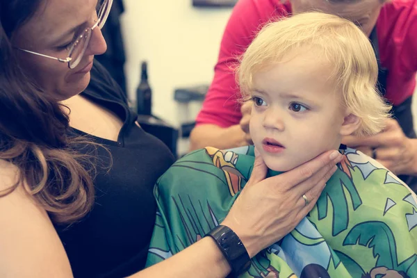 Cute blonde girl having her first haircut. — ストック写真