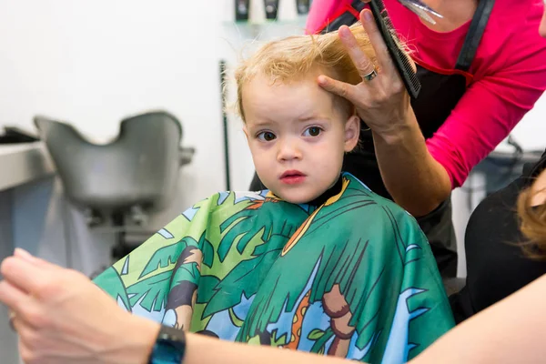 Cute blonde girl having her first haircut. — ストック写真