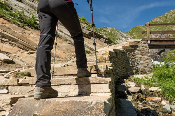 Low angle view of hikin boots ascending steps.