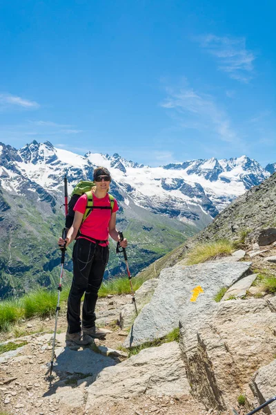 Jeune brune posant à un panneau de direction dans les montagnes . — Photo
