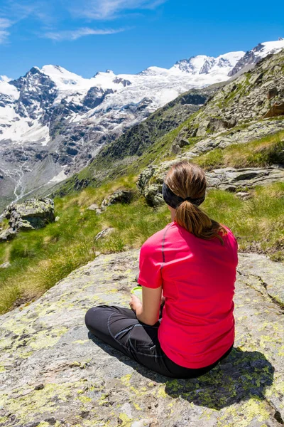 Resimli dağlarda meditasyon yapan çekici esmer kadının arkadan görünüşü. — Stok fotoğraf