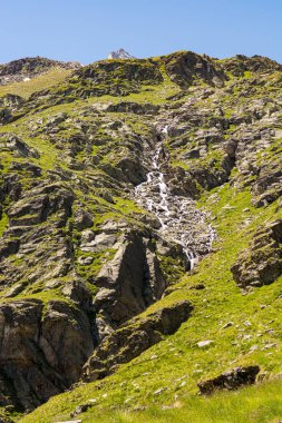 Mountain stream rushing down a steep slope.