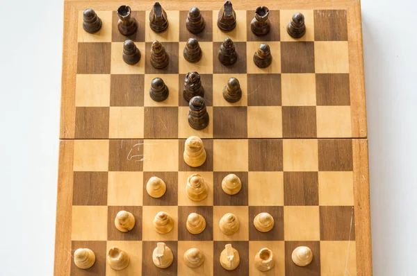 Drop down view of a chess board with wooden figures. — ストック写真