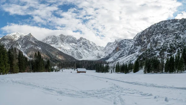 Spektakulärt vinterlandskap med nyfallen snötäckt fjällstuga omgiven av berg. — Stockfoto