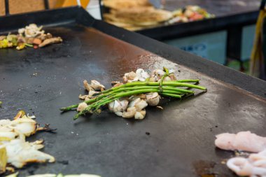 Şef sıcak ızgarada geleneksel Akdeniz mürekkep balığı yemeği hazırlıyor..