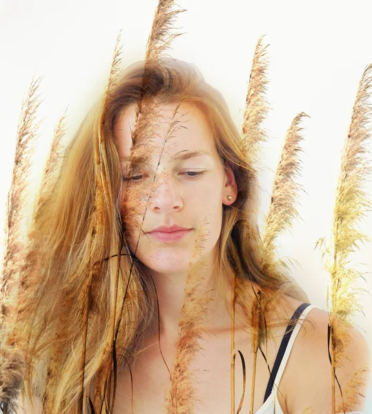 Half-portrait of a very young woman with red blond long hair in frontal view — Stock Photo, Image