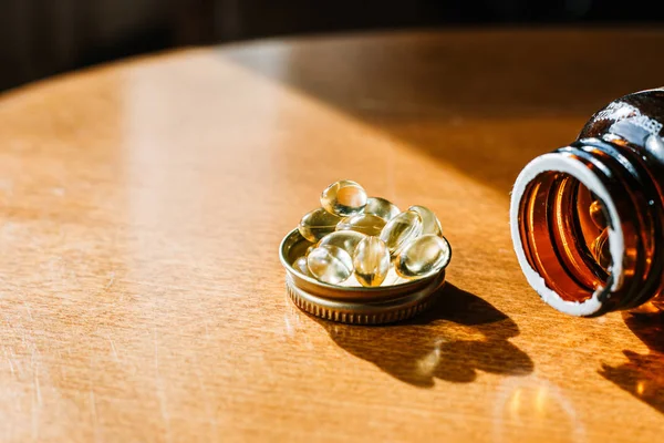 Bottle and of fish oil vitamin D transparent capsules. Dietary supplements. — Stock Photo, Image