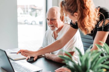 Middle aged business with assistant standing next to him. Bussines concept