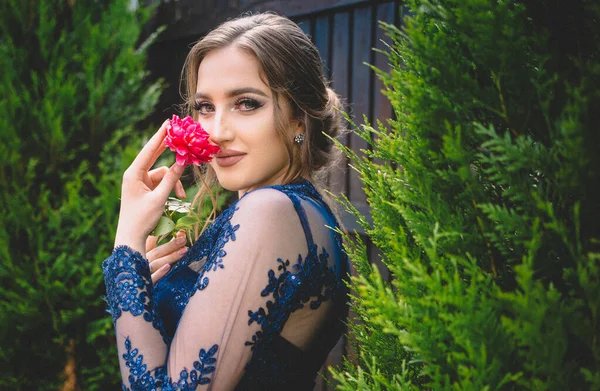 Όμορφο κορίτσι σε λαμπερό ultramarine φόρεμα κρατώντας ένα τριαντάφυλλο. Έτοιμος για το χορό. — Φωτογραφία Αρχείου