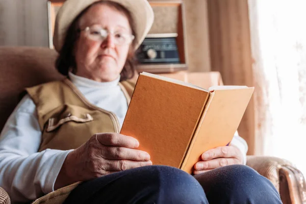 Elderly Woman Hat Reading Book Window Afternoon Light — Stock Photo, Image