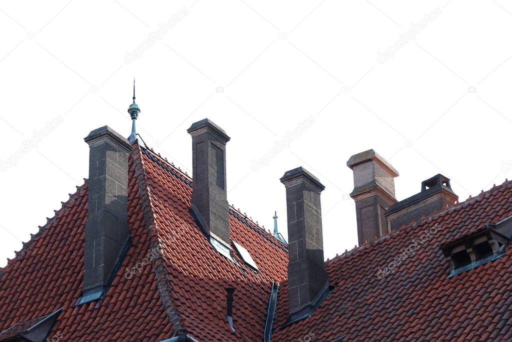 Old brick chimneys on the red roof of a historic building separated on a white background.