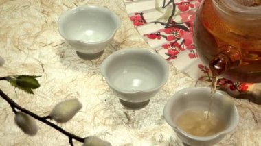 Kore geleneksel çay çaydanlık ve beyaz bardak fan ve çiçekler arka plan üzerinde