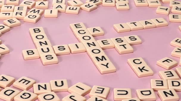 女性手在粉红色背景下的商业 资本和股票词的拼字游戏裁剪视图 — 图库视频影像